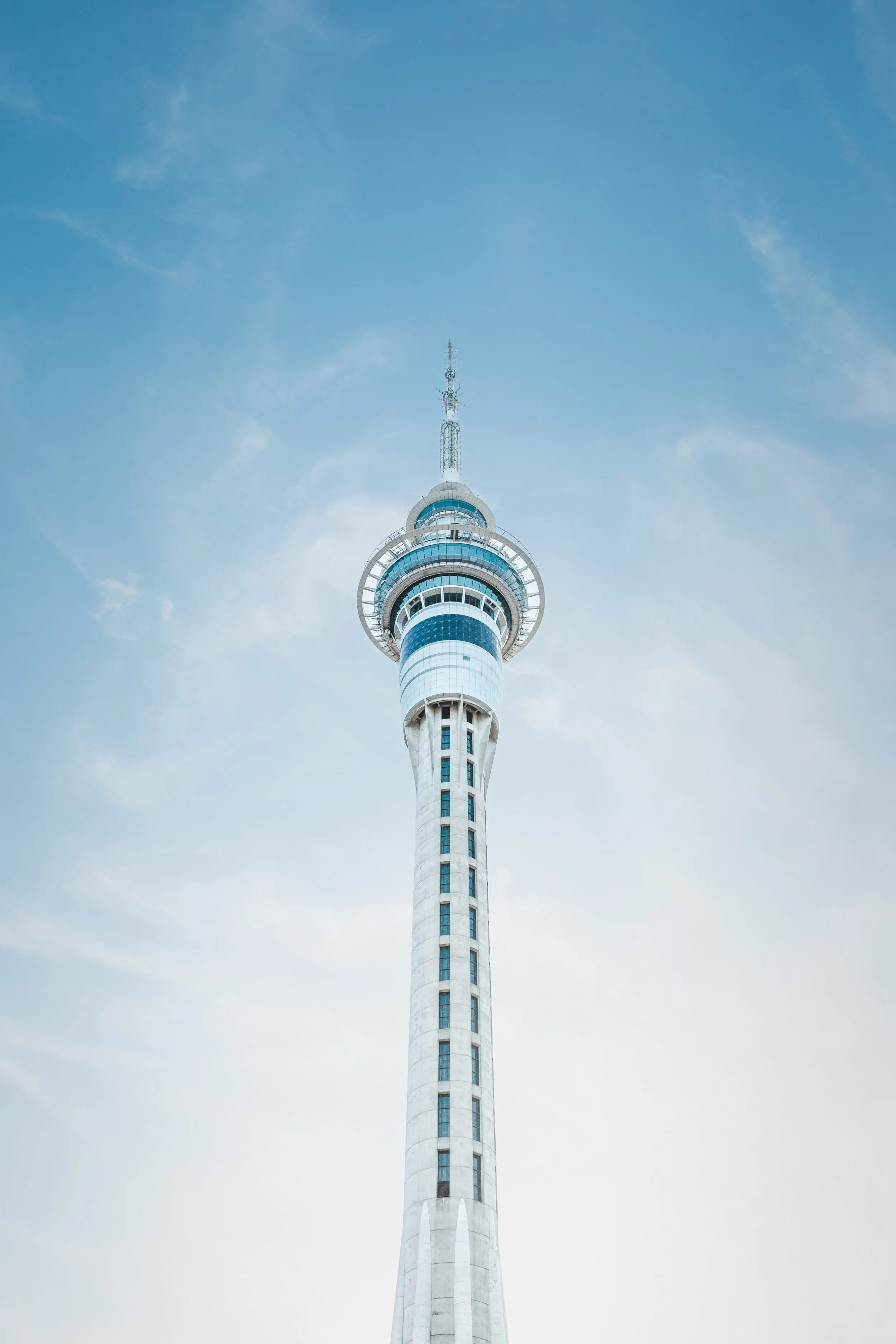 Auckland Sky Tower from below against a pale blue sky