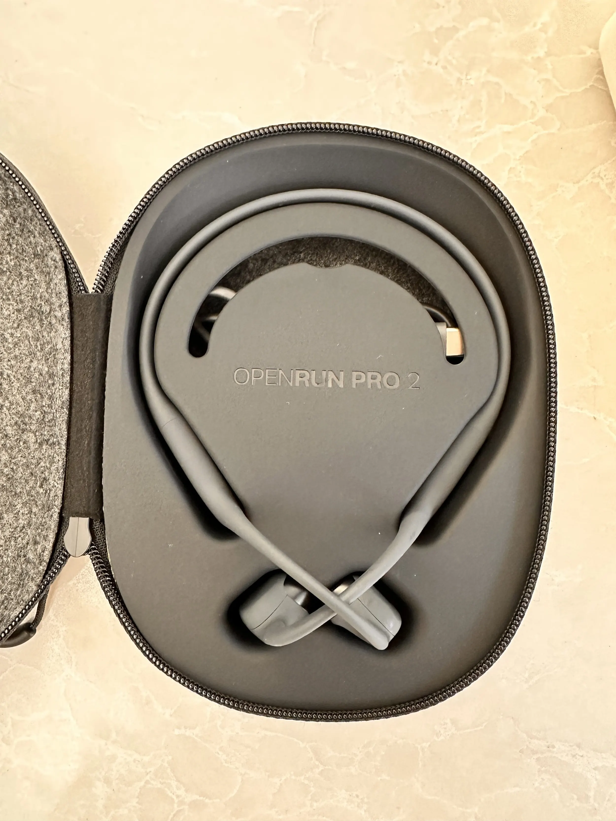 Shokz OpenRun Pro 2 headphones in their open carry case