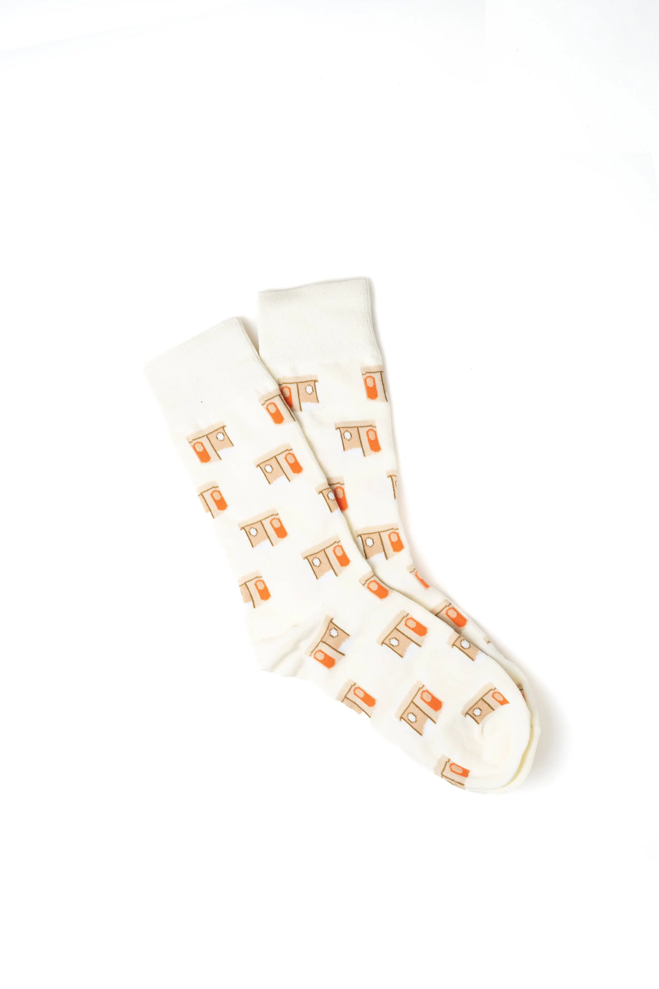 A pair of white socks with an orange and beige house pattern on a white background.