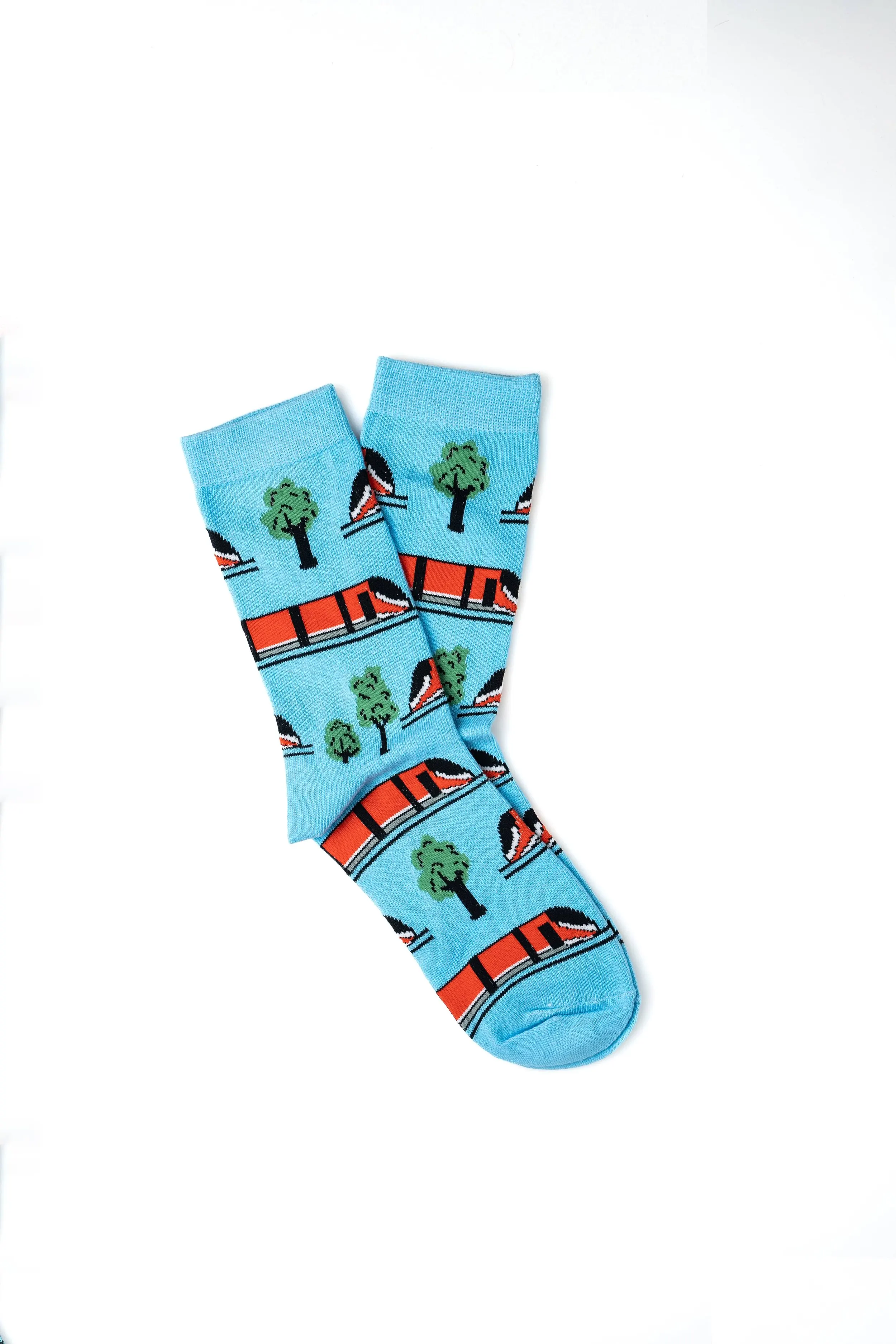 Pair of blue socks with a pattern of trees and boats.