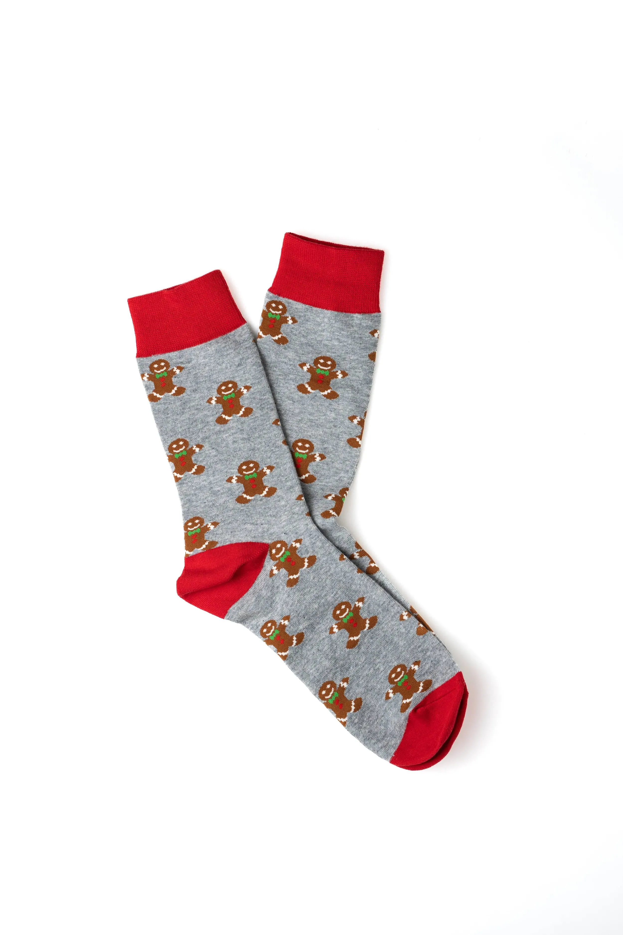 Gray Christmas socks with gingerbread men pattern, red toe, heel, and cuff, laid on a white background.