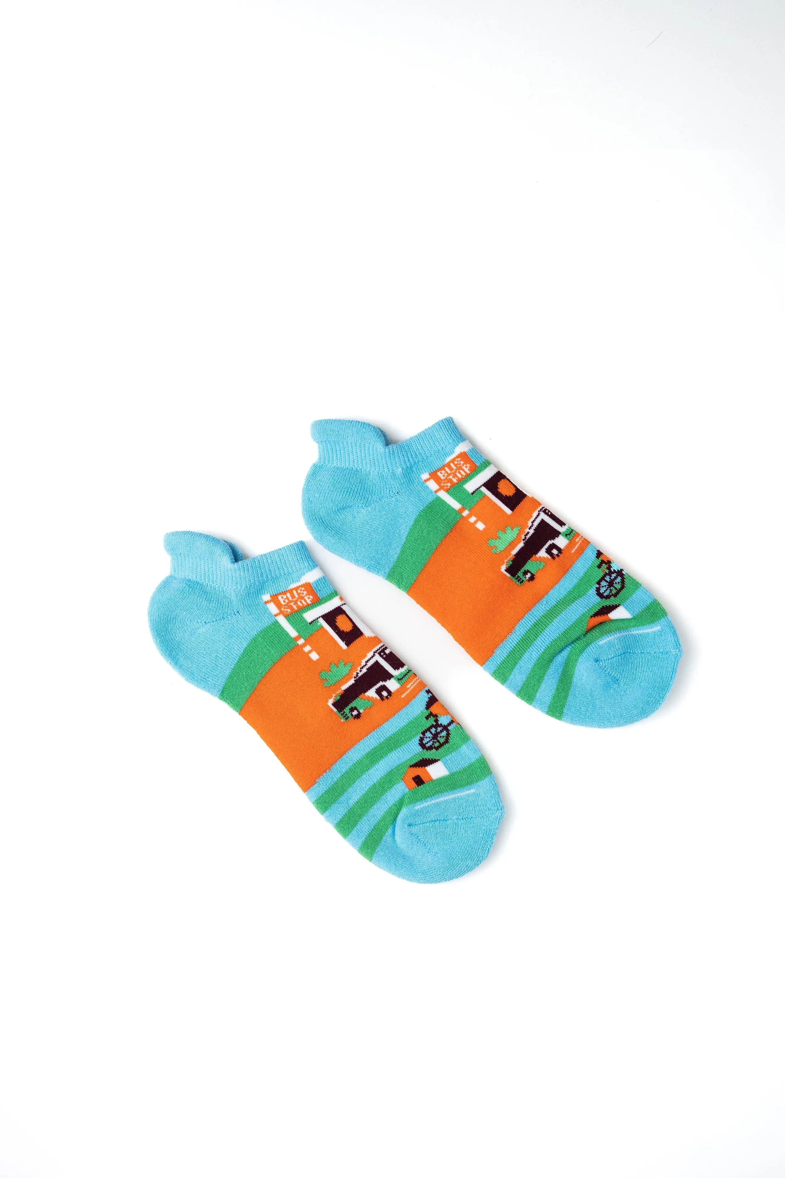 Colorful children's ankle socks with a farm scene and farm animals on a white background.