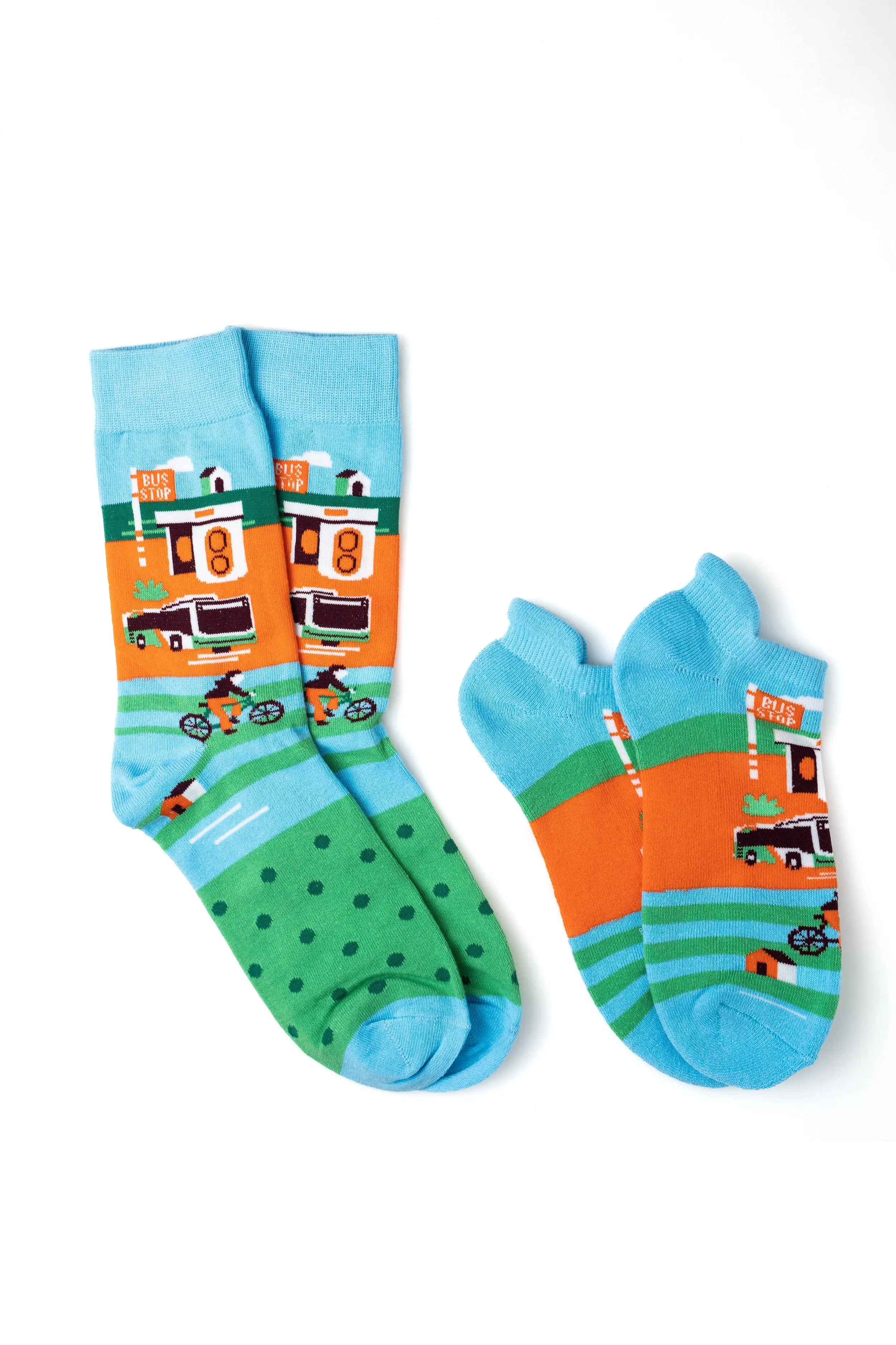 Pair of colorful novelty socks with a bus stop and bike path pattern on a white background.