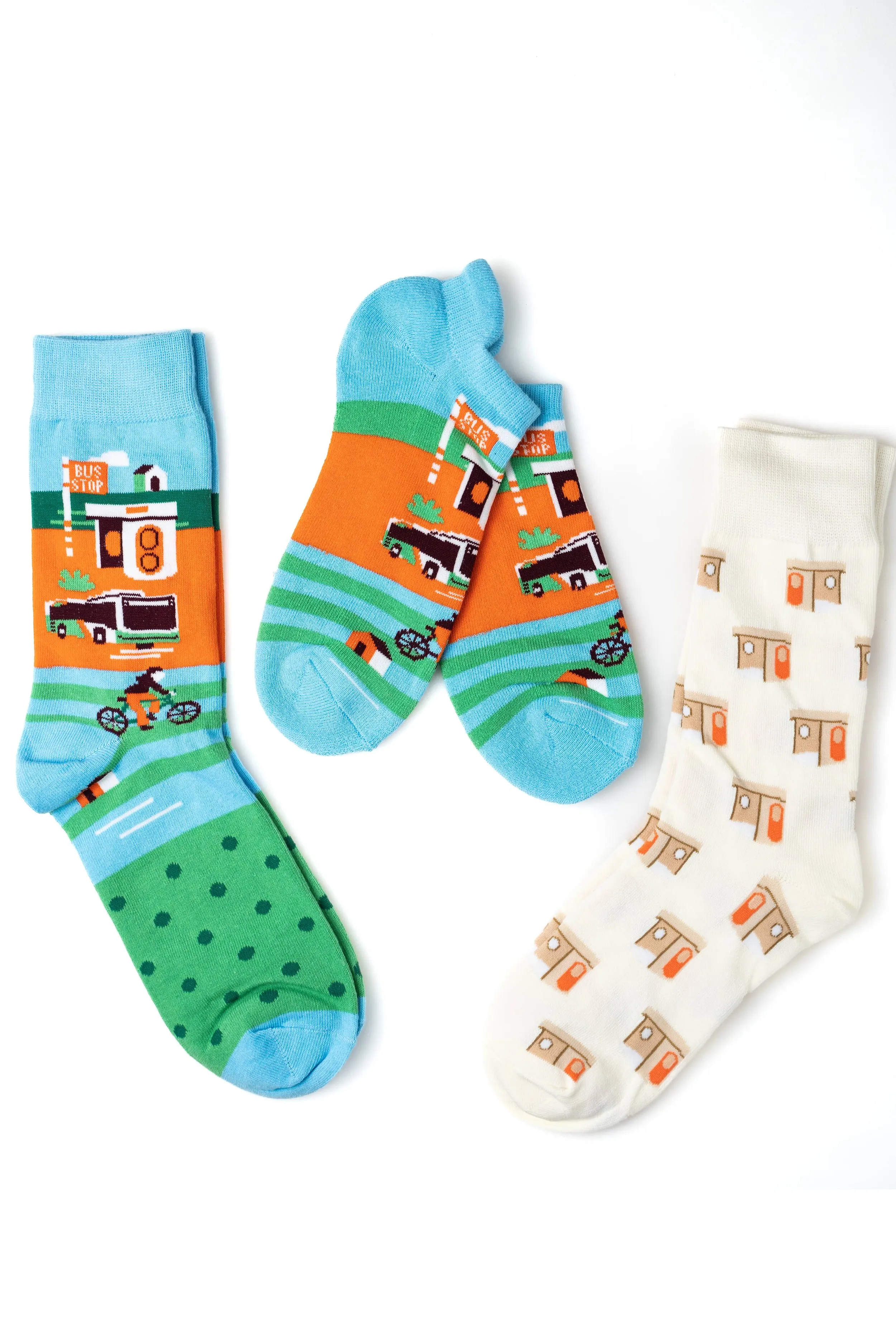 Three pairs of colorful patterned socks with transportation theme on a white background.